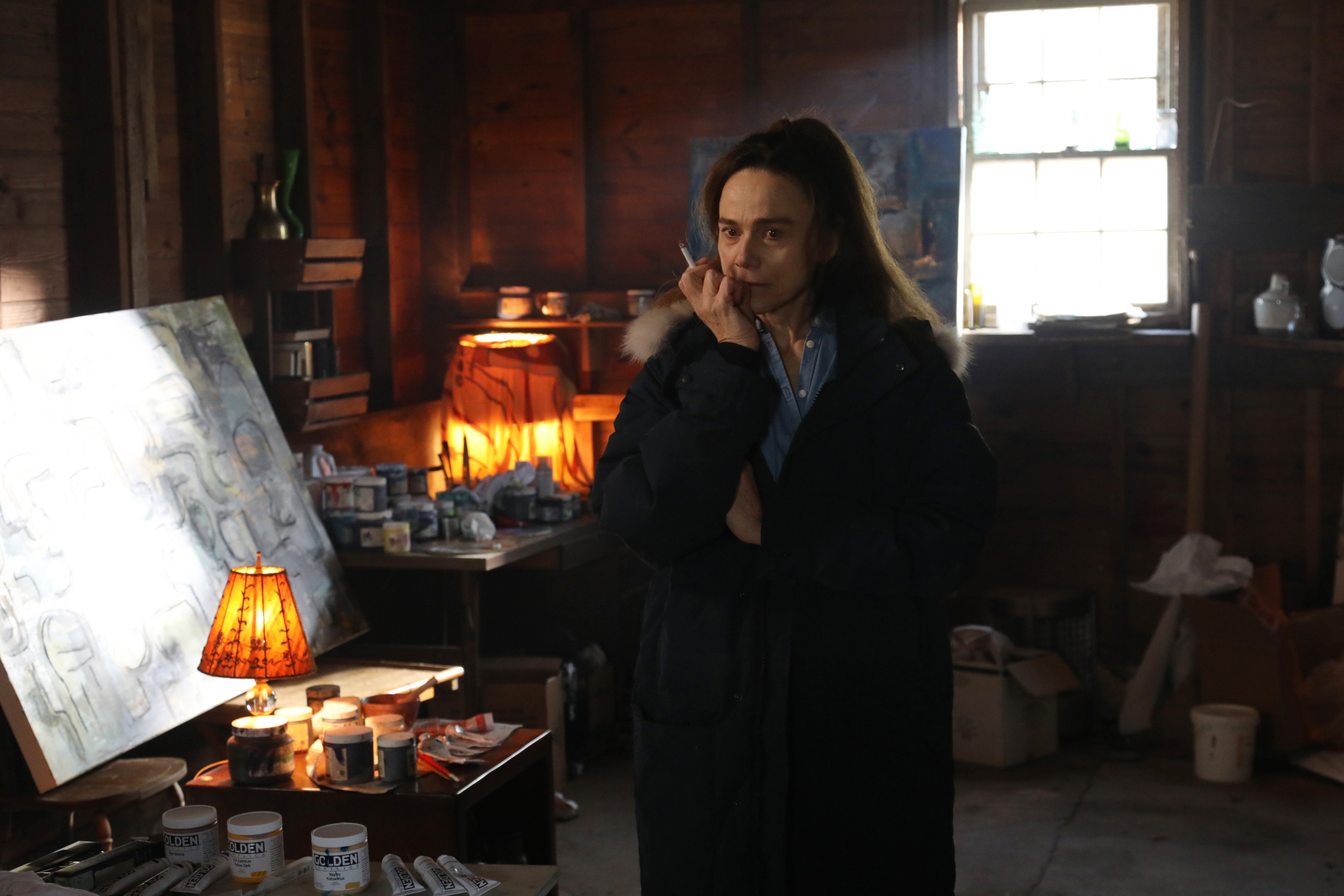 Claire (Lena Olin) thinks about her next move in her barn studio in THE ARTIST’S WIFE. Photo by Michael Lavine.