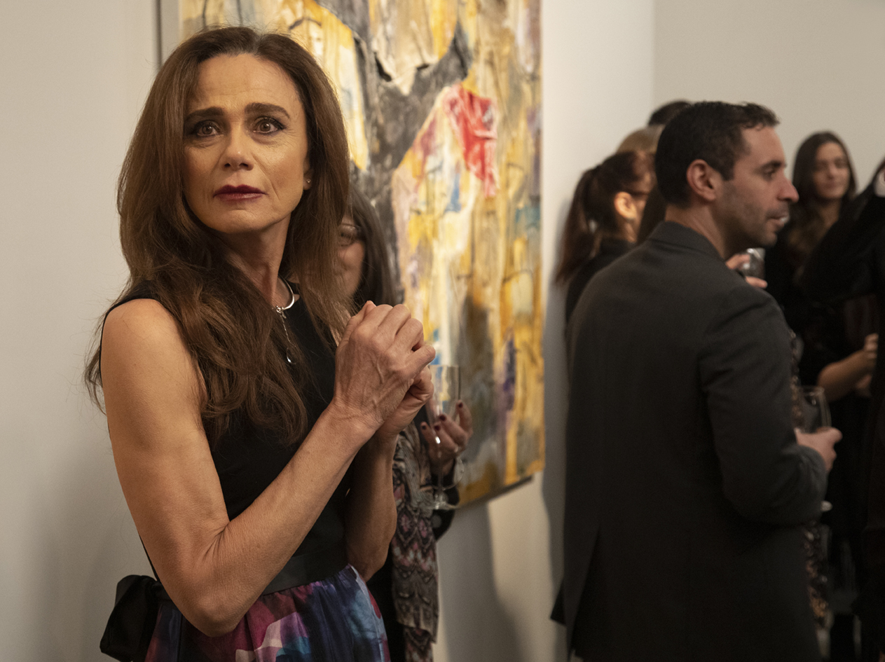Claire (Lena Olin) hesitantly takes in the scene at Richard’s long-awaited opening in THE ARTIST’S WIFE. Photo by Michael Lavine.
