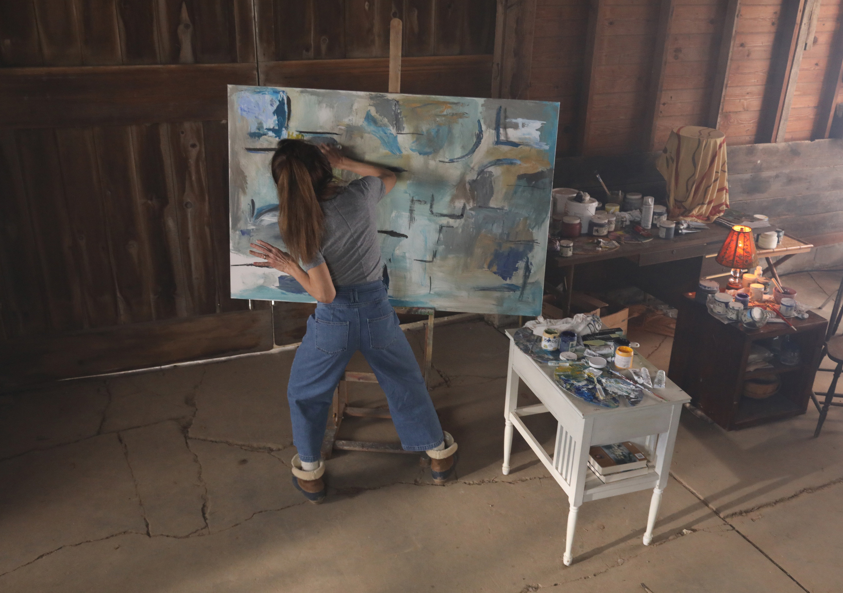 Claire (Lena Olin) painting in her barn studio in THE ARTIST’S WIFE. Photo by Michael Lavine.